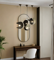 Modern interior with a vanity table, chair, and decorative mirror with unique light fixtures.