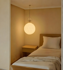 Bedroom with a round pendant light fixture casting a warm glow.