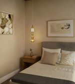 Modern bedroom with a bed, nightstand, and wall art.