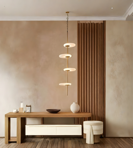 Modern interior with a wooden console table, decorative items, and a pendant light fixture.