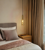 Bedroom with a bed, nightstand, and pendant light fixture.