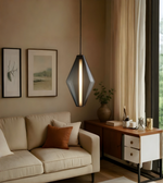 Modern living room with a beige sofa, geometric pendant light, and a desk.