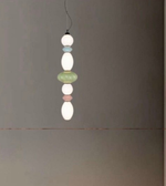 Pendant light with colorful beads on a plain background