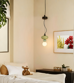 Bedroom interior with a bed, lamp, and wall art.