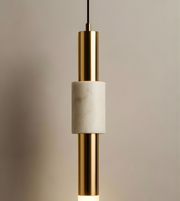 Pendant light with gold and white design on a neutral background