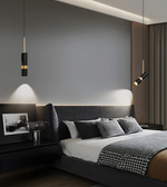 Modern bedroom with dark gray walls, a bed with patterned bedding, and pendant lights.