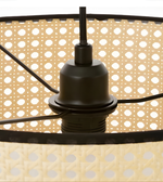 Close-up of a black lampshade with a beige and white polka dot pattern.