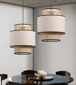 Modern pendant lights hanging above a dining table with a neutral background