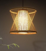 Woven pendant light with a warm glow on a dark background