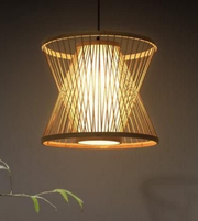 Woven pendant light with a warm glow on a dark background