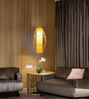 Modern living room with a pendant light, sofa, and side table.