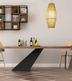 Modern dining room with a long wooden table, chairs, and a pendant light.