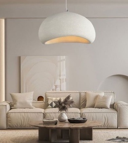 Modern living room with a beige sofa, wooden coffee table, and pendant light.