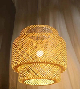 Woven pendant light hanging against a neutral background
