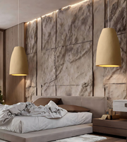 Modern bedroom with stone wall, bed, and pendant lights