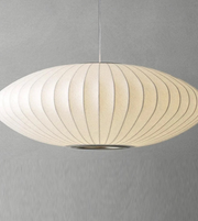 Pendant light with ribbed design on a gray background
