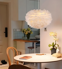 Modern kitchen with a round dining table, chairs, and a decorative ceiling light.