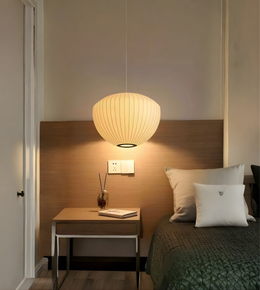 Modern bedroom with a pendant light, bed, and desk.