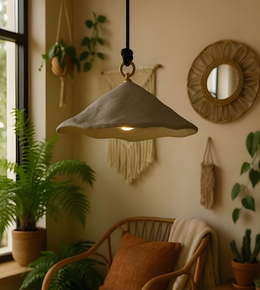 Pendant light fixture in a cozy room with plants and decor
