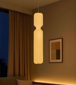 Modern pendant light hanging in a room with a window and framed picture on the wall.