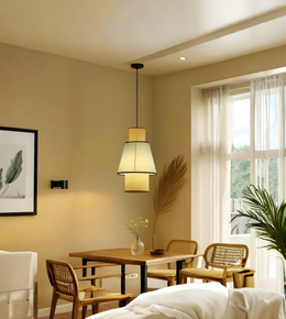 Dining room with wooden table, wicker chairs, and pendant light fixture.