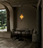 Daya Worldwide AURUM sculpted glass drop pendant light hanging from ceiling, modern design with clear glass shade.