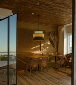 Dining area with wooden tables and chairs in a modern interior setting.