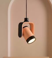 Modern pendant light with pink and black design on a neutral background