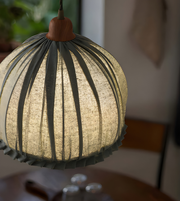 Textured spherical pendant light with a blurred background
