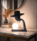 Modern sculptural table lamp with human figure design and glowing orb light for luxury interior décor