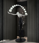 Modern sculptural floor lamp with human figure design and curved globe lights for luxury interior décor