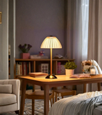 Modern bedside lamp glowing in cozy bedroom