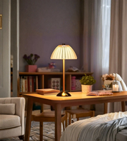 Modern bedside lamp glowing in cozy bedroom