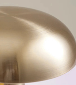 Close-up of brushed gold dome shade table lamp