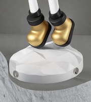 Detailed view of gold astronaut boots on sculpted base
