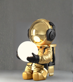 Side view of gold astronaut lamp with backpack detailing