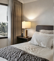 Modern gold table lamp styled on bedside table in bedroom