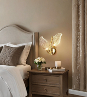 Luxury gold wall sconce with leaf design illuminating a cozy interior space