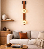 dual globe leather strap wall light with warm glow mounted in living room, modern decorative wall lighting