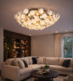 Luxury floral glass ceiling chandelier with gold finish illuminating modern living room with warm ambient lighting