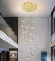 Elegant cascading floral chandelier with gold ceiling plate in modern luxury interior space