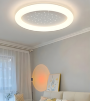 Ceiling light fixture in a room with a couch and decorative items.