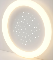 Round light fixture with a starry night design on a white background