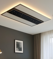 Ceiling-mounted air conditioning unit in a room with a gray wall and window.