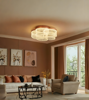 Modern living room with a ceiling light fixture, sofa, and armchair.