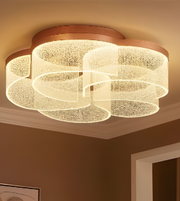 Ceiling light fixture with wooden frame and glass diffuser in a room setting