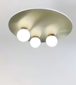 Ceiling light fixture with three round lights on a plain background