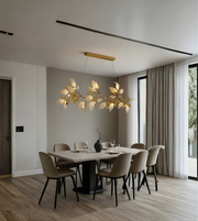 Modern dining room with a stylish chandelier, table, and chairs.