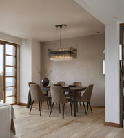 Dining room with a modern chandelier, table, and chairs.