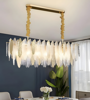 Luxury chandelier with gold frame and glass shades in a dining room setting.